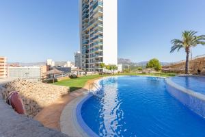 a large swimming pool in front of a tall building at Benidorm HEAVEN 29th floor in Benidorm