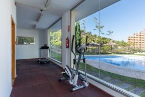 a room with a gym with a view of a swimming pool at Benidorm HEAVEN 29th floor in Benidorm