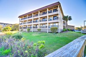 an apartment building with a lawn in front of it at Beach View, Pool and Tennis Hilton Head Island Unit in Hilton Head Island