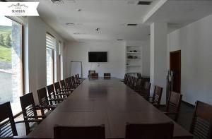 a large conference room with a long table and chairs at Hotel Scardus in Tetovo