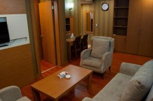 a living room with a couch and chairs and a table at luna hotel in Erbil