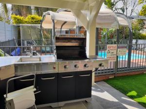 a grill in a backyard with aesteadangering at Love & Lemons in Yesod Hamaala