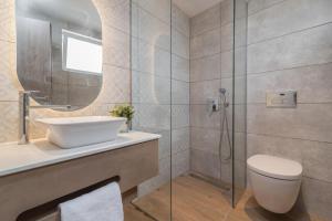 a bathroom with a sink and a toilet and a shower at Mavra Elegant Apartments in Zakynthos Town