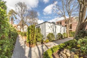 an exterior view of a house with a garden at New Comfortable 2 Bedroom Cottage w/Big Terrace in Jūrmala