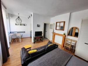 a living room with a couch and a table at PIF Apartments Sadoveanu in Braşov