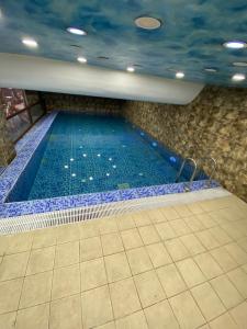 a large swimming pool in a building at luna hotel in Erbil