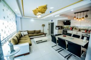 a large living room with a couch and a kitchen at Rosa Therapy Butik Otel in Isparta