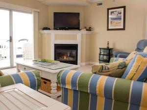 a living room with two couches and a fireplace at Bahia Vista I in Ocean City