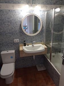 a bathroom with a sink and a toilet and a mirror at The Torrent's Observer Holiday Home ( Cala Pi ). Smart Tv. Netflix. Free Wifi in Cala Pi