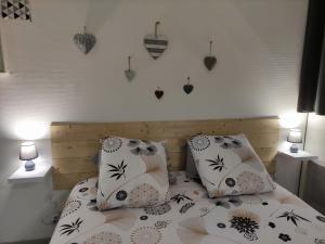 a bedroom with a bed with two pillows on it at Joli petit T2 terrasse proche du phare in Calais