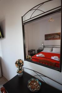a bedroom with a large mirror on the wall at Cyclades Beach in Platis Yialos Sifnos