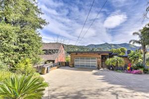 a house with a garage and mountains in the background at Designer Apartment Less Than 1 Mile to Downtown San Rafael in San Rafael
