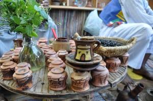 a table with a bunch of pottery on it at Nubian Farm Aswan in Aswan +37 photos