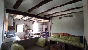 a living room with a couch and a table at Casa Sisco, dins de la Vall d'Àger in Ager