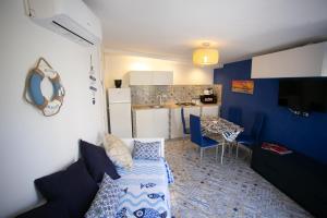 a living room with a couch and a table and a kitchen at DilettaAnna Luxury apartment Lipari in Tropea