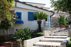 a staircase leading to a house with blue shutters at DilettaAnna Luxury apartment Lipari in Tropea