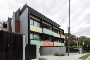 an exterior view of a building with colorful balconies at Stylish 2-Bed Apartment with BBQ Patio Near Beach in Sydney