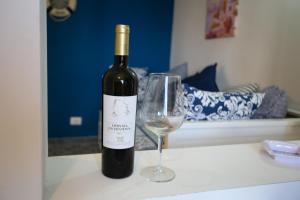 a bottle of wine and a wine glass on a counter at DilettaAnna sea view appartment in Tropea