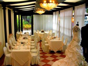 a banquet room with white tables and white chairs at Albergo Ristorante Da Giuseppe in Copparo