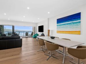 a living room with a table and a couch at Oceania 3 in Lorne