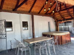 a table and chairs in a building with a table and chairs at Martyrs Guest House in Vanderbijlpark