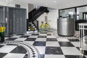 a black and white checkered floor in a room with bikes at Staypineapple, A Delightful Hotel, South End in Boston