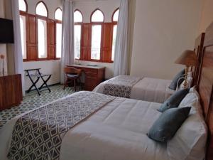 Säng eller sängar i ett rum på HOTEL CASA CONSTANZA