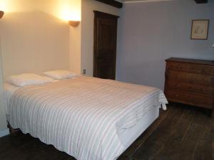 ein Schlafzimmer mit einem weißen Bett und einer Kommode in der Unterkunft Lavish Holiday Home in Forri res with Sauna in Lesterny