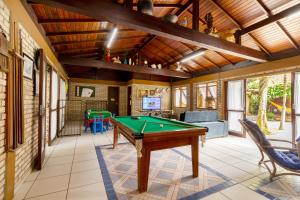 a room with a pool table in a house at Estalagem Don Pablo in Bombinhas