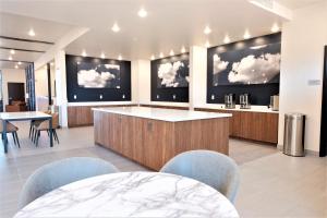 a large room with a kitchen with clouds on the walls at Scenic View Inn & Suites Moab in Moab