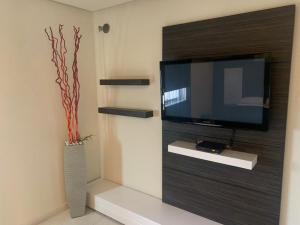 グアダラハラにあるMotel Casablancaの壁に薄型テレビが取り付けられたリビングルーム