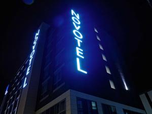 a building with a blue sign on the side of it at Novotel London Brentford in Brentford