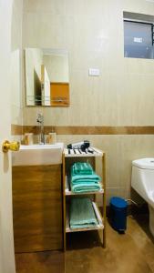 a bathroom with a sink and a mirror at Ickota B&B in San Pedro de Atacama