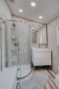 y baño con ducha, aseo y lavamanos. en Modern & Cozy stand-alone apartment - perfect stay, en Painted Post