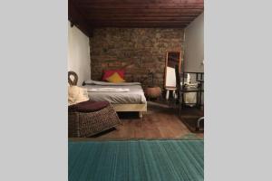 a bedroom with a bed and a stone wall at Studio Lyon 1er in Lyon
