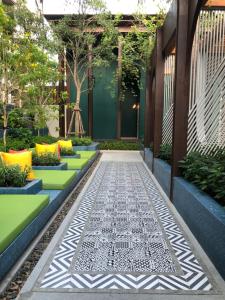 a courtyard with a patterned walkway in front of a building at La HABANA Condo 135/500 in Hua Hin