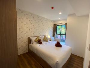 a bedroom with a bed with two teddy bears on it at La HABANA Condo 135/500 in Hua Hin +28 photos