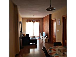 a living room with a couch and a table at 2 bedrooms appartement with balcony and wifi at Las Gabias in Las Gabias