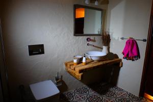 a bathroom with a sink and a toilet and a mirror at Exclusive Boutique Hotel in Kızılcakaya