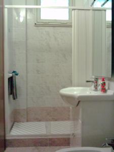 a bathroom with a shower and a sink and a toilet at APARTMENT IN VILLA (NEAR THE SEA) in Porto Palo