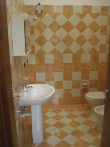 a bathroom with a sink and a toilet at Apartment Eutime- in Locri