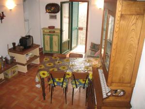 a dining room with a table and chairs in a room at The Costantinos home in the green heart of Tuscany in Ruosina