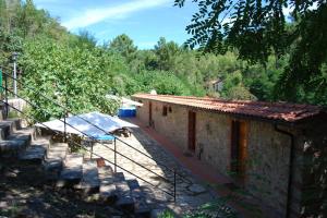 a house with a staircase next to a building at Rustic Tuscan Apartment in Massa Marittima +10 photos