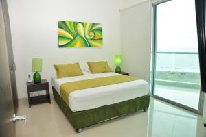a bedroom with a bed with a view of the ocean at MODERN 3 ALCOBAS APARTMENT in Cartagena de Indias