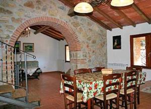 a dining room with a table and chairs at Apartment immersed in the green of the Maremma in Massa Marittima