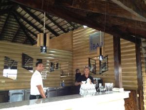 a man and a woman standing at a bar at Junior Suite in Puerto Plata at Lifestyle Holidays Vacation Club in San Felipe de Puerto Plata