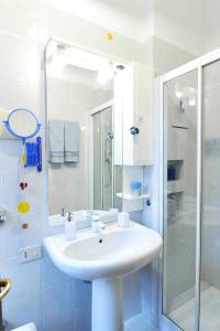 a white bathroom with a sink and a shower at SantaMarta, the apartment for your Venetian holidays in Venice