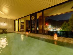 a swimming pool on the side of a building at Yukai Resort Premium Gero Saichoraku Honkan in Gero