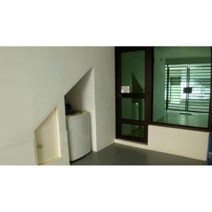 an empty room with a window and a refrigerator at Holiday home in Gaira in Santa Marta