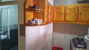 a bathroom with wooden cabinets and a sink at Surfapartment Taghazout Nr 6 in Taghazout